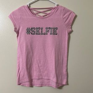 This is a cute pink top, size L or 10/12, from ‘The Children’s Place’